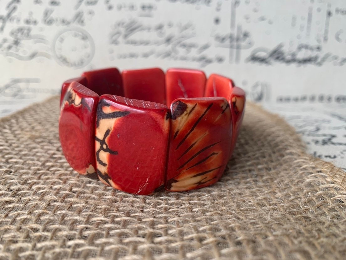 Red beaded bracelet Tagua nut jewelry Spring fashion trends Elastic stretch bracelet Geometric beads bracelet Art to wear Wide cuff bracelet