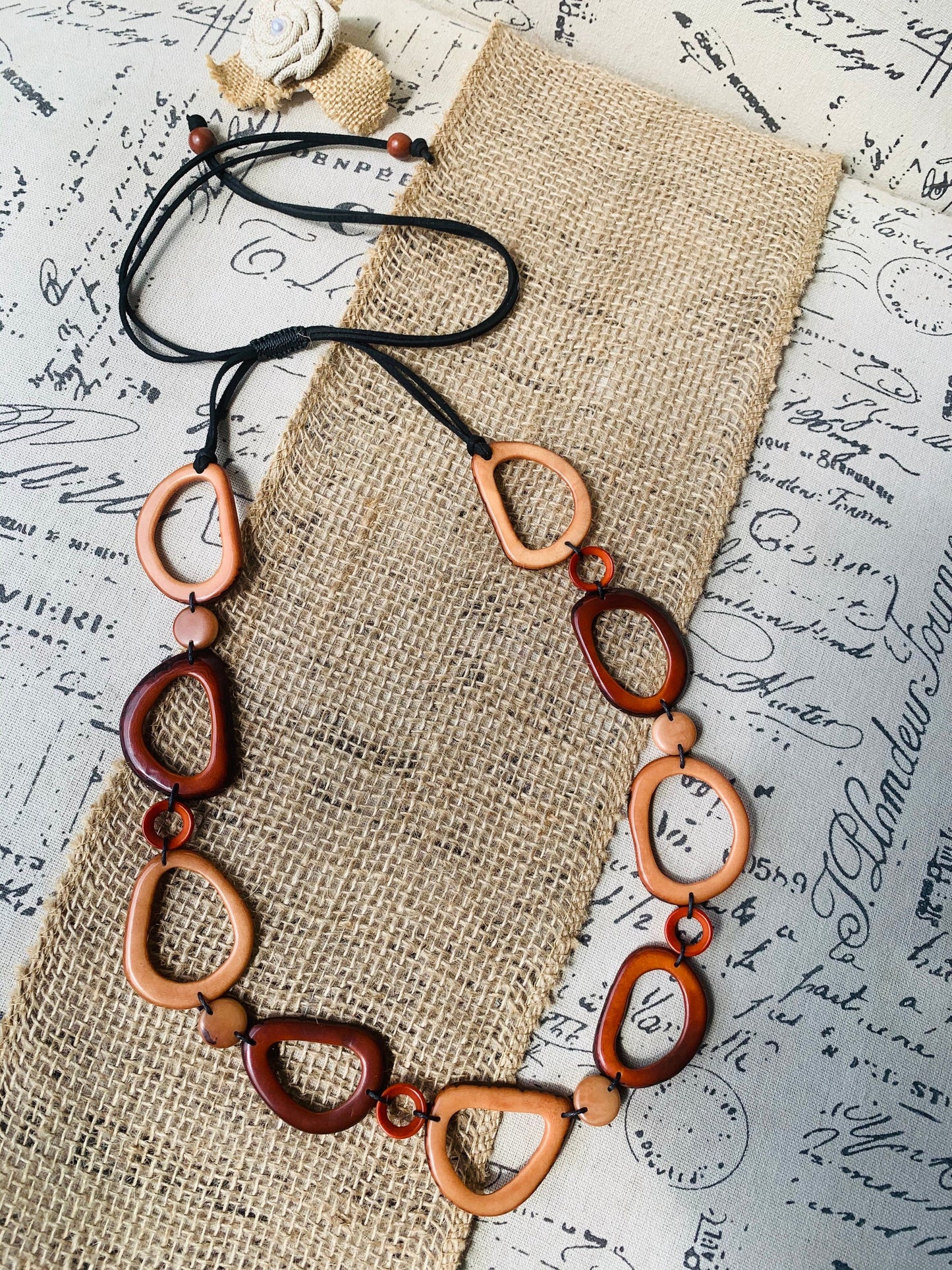 Brown Tagua necklace Fall fashion trends 2023 Statement geometric jewelry Donut beads Modern adjustable collar Lightweight extra long