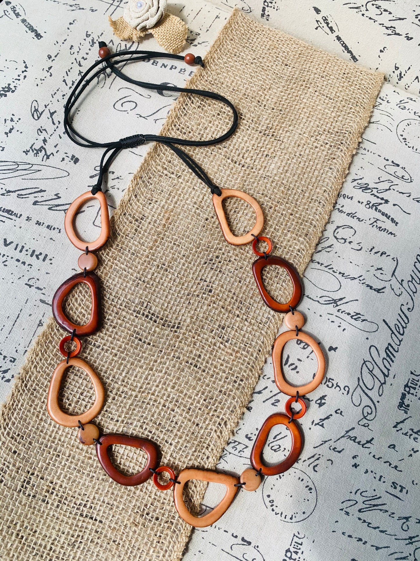 Brown Tagua necklace Fall fashion trends 2023 Statement geometric jewelry Donut beads Modern adjustable collar Lightweight extra long