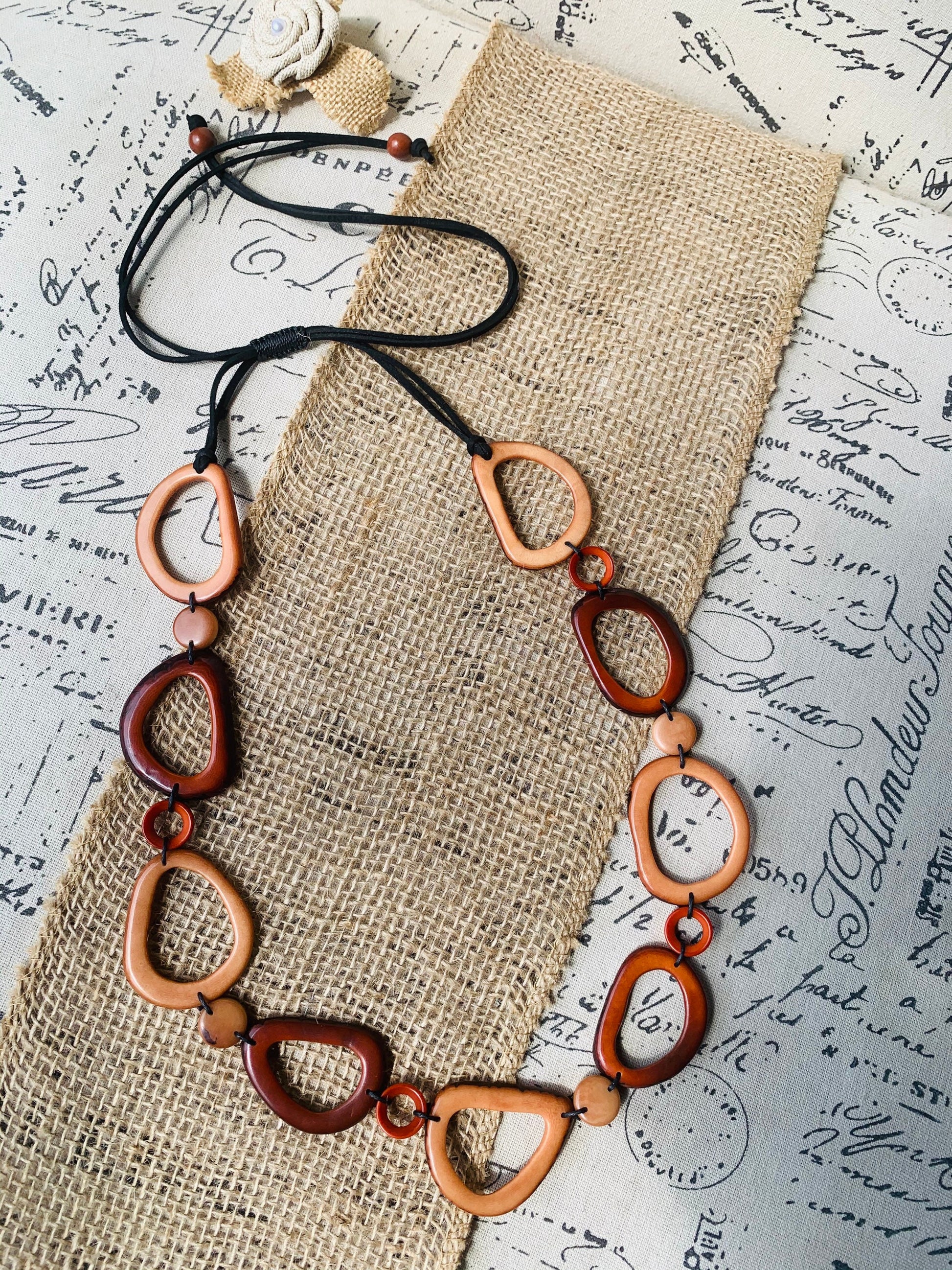 Brown Tagua necklace Fall fashion trends 2023 Statement geometric jewelry Donut beads Modern adjustable collar Lightweight extra long