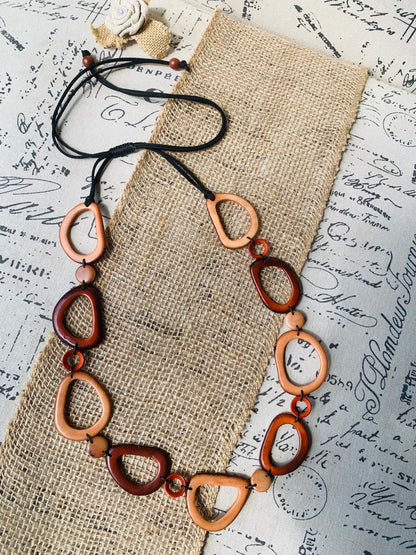 Brown Tagua necklace Fall fashion trends 2023 Statement geometric jewelry Donut beads Modern adjustable collar Lightweight extra long