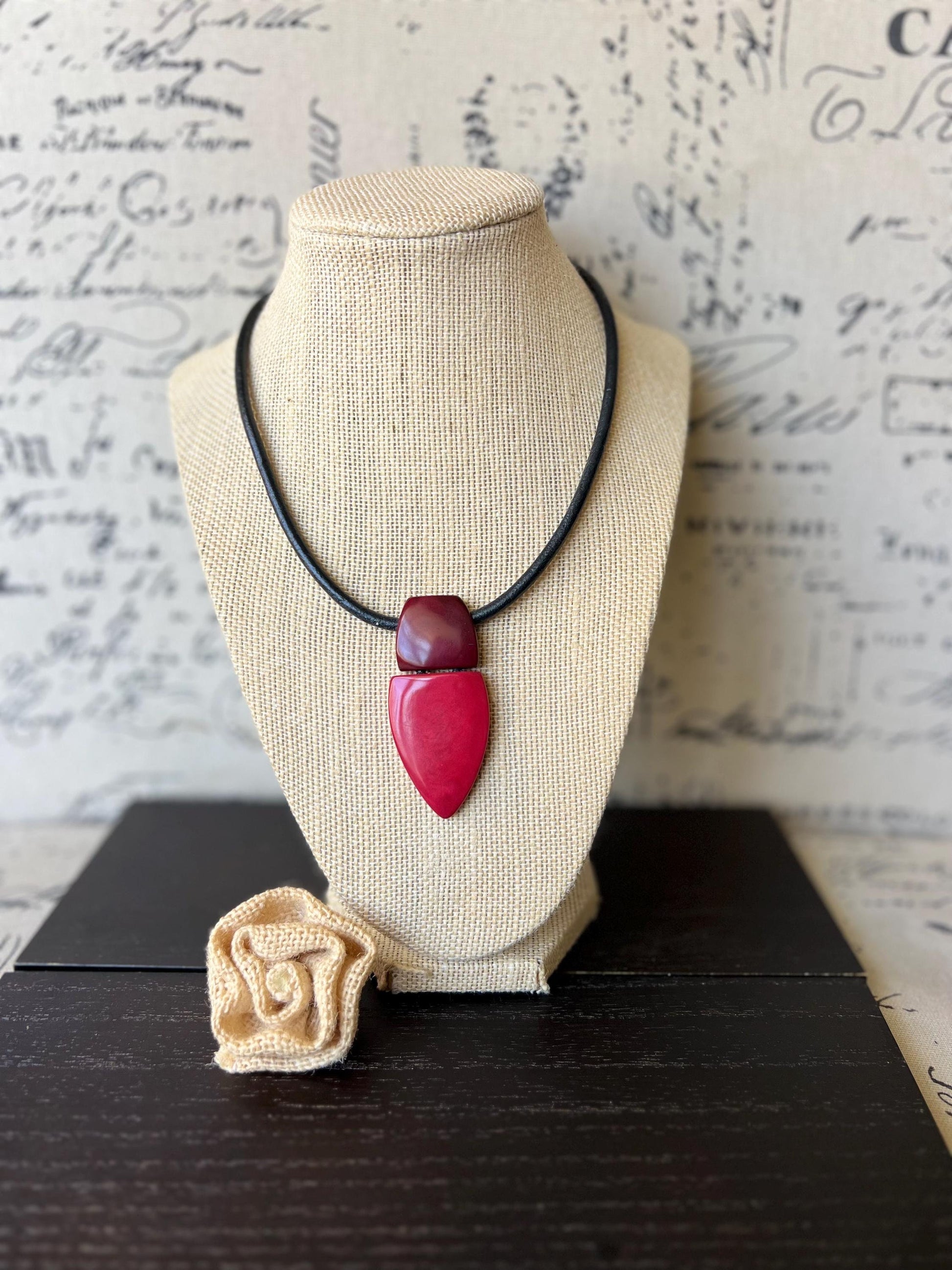 Red and burgundy pendant necklace.
Red pendant necklace.
Tagua necklace.