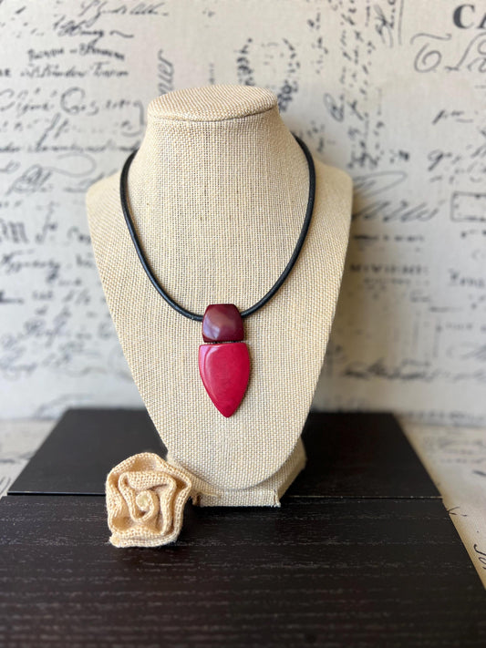 Red and burgundy pendant necklace.
Red pendant necklace.
Tagua necklace.