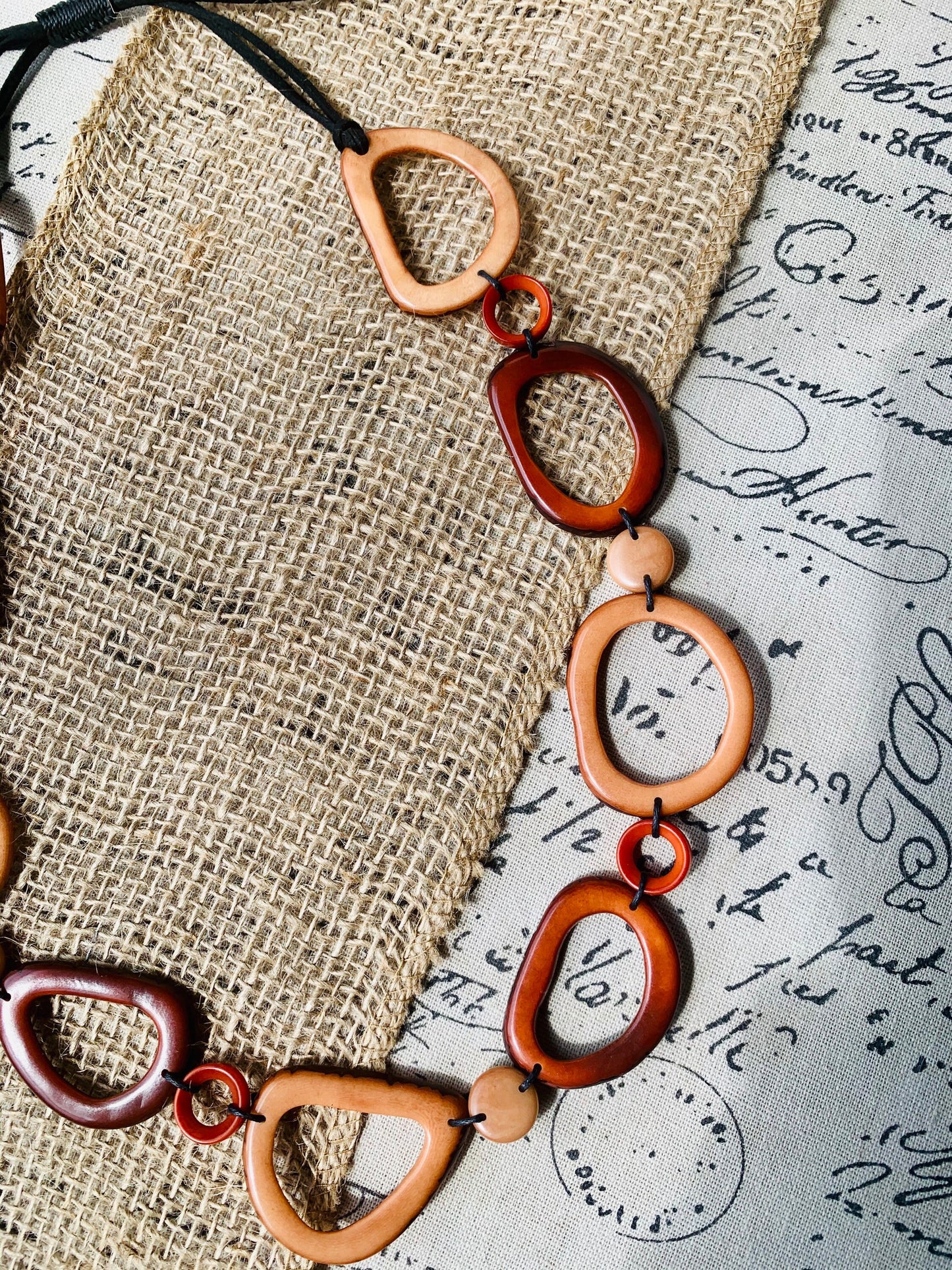 Brown Tagua necklace Fall fashion trends 2023 Statement geometric jewelry Donut beads Modern adjustable collar Lightweight extra long