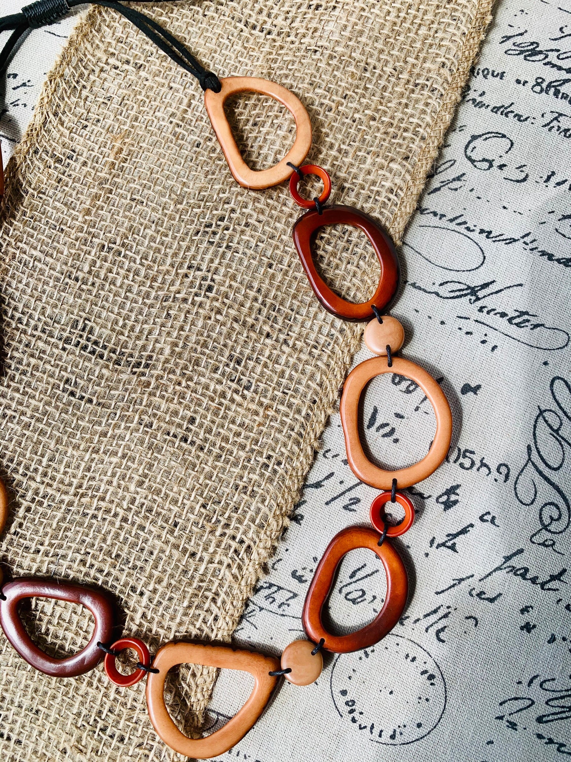 Brown Tagua necklace Fall fashion trends 2023 Statement geometric jewelry Donut beads Modern adjustable collar Lightweight extra long