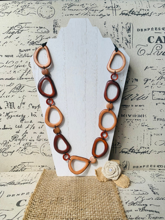 Brown Tagua necklace Fall fashion trends 2023 Statement geometric jewelry Donut beads Modern adjustable collar Lightweight extra long
