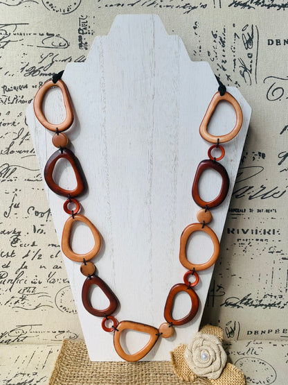 Brown Tagua necklace Fall fashion trends 2023 Statement geometric jewelry Donut beads Modern adjustable collar Lightweight extra long